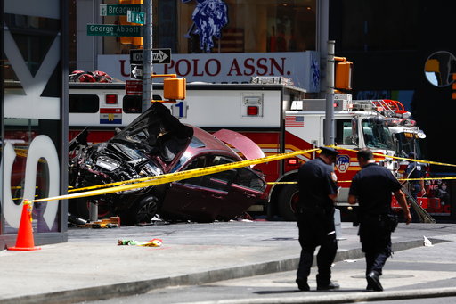 A smashed car sits on the corner of Broadway and 45th Street in New York's Times Square after ploughing through a crowd of pedestrians at lunchtime on Thursday