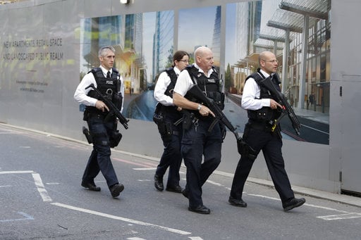 A group of armed British police officers walk together after an attack in the London Bridge area of London