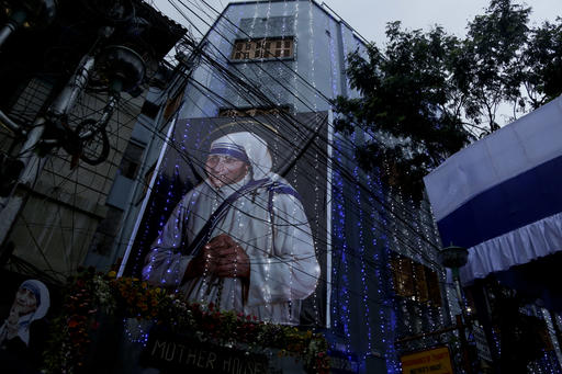 Mother House of the Missionaries of Charity group founded by Mother Teresa is illuminated with a huge portrait of her displayed in Kolkata