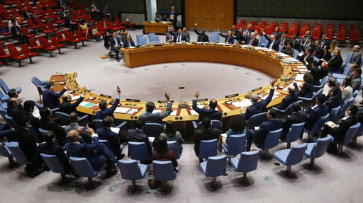 Ambassadors to the United Nations raise hands in a U.N. Security Council resolution vote to sanction North Korea