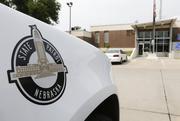 A vehicle with the Nebraska State Patrol logo is parked in a state patrol facility in Omaha