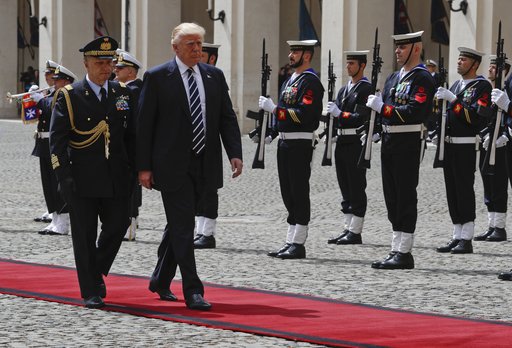 President Donald Trump is flanked by Italian President's military advisor Gen. Roberto Corsini as he reviews the honor guard at the Quirinale Presidential palace prior to his meeting with Italian President Sergio Mattarella
