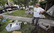Barron Lazano looks over the damaged to her home and property in the aftermath of Harvey Wednesday