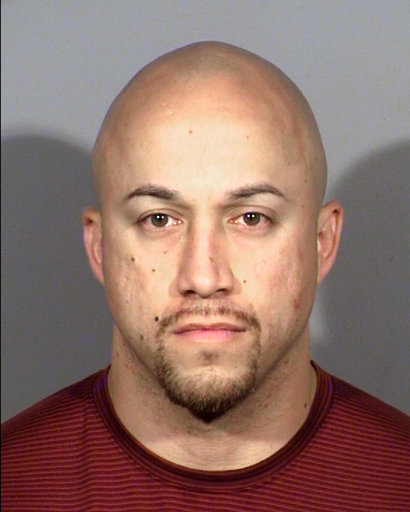 This undated photo provided by Clark County Detention Center shows Las Vegas police officer Kenneth Lopera. Sheriff Joe Lombardo said Lopera was suspended without pay and arrested Monday