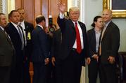 President Donald Trump waves to reporters after a lunch with Republican senator at the U.S. Capitol Tuesday