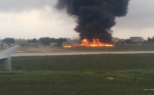 In this image taken from a video smoke billows as a light plane crashed after takeoff from Malta airport