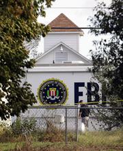A law enforcement official investigates the scene of a shooting at the First Baptist Church of Sutherland Springs