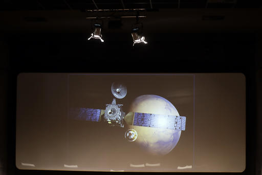 A rendering of the Schiaparelli Space Module and of the planet Mars is displayed on a movie screen during an event organized by Italy's Space Agency on the occasion of the insertion of the Trace Gas Orbiter into orbit around Mars