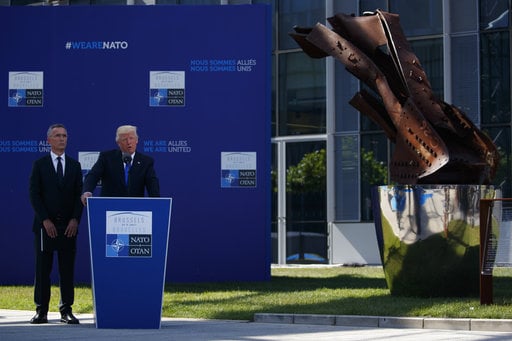 NATO Secretary General Jens Stoltenberg listens as President Donald Trump speaks during a ceremony to unveil artifacts from the World Trade Center and Berlin Wall for the new NATO headquarters