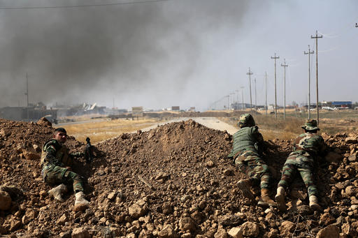 Kurdish security forces take up a position as they fight overlooking the Islamic State-controlled in villages surrounding Mosul