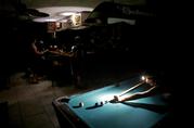Lisa Borruso plays pool using a headlamp as the power remains out following Hurricane Irma at Gators' Crossroads in Naples