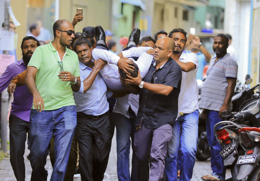 Maldivian lawmaker Faisal Naseem who was injured in clashes with police is rushed to a hospital in Male