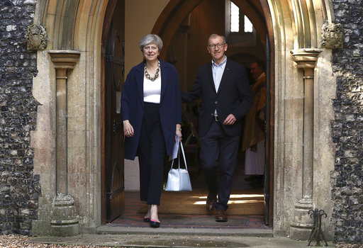 Britain's Prime Minister Theresa May and her husband Philip leave after attending Holy Communion at St Andrew's Church in Sonning