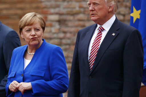German Chancellor Angela Merkel and President Donald Trump pose for a family photo with G7 leaders at the Ancient Greek Theater of Taormina