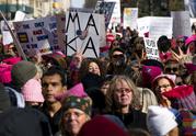 People line up on Central Park West as they wait for the start of a march highlighting equal rights and equality for women Saturday