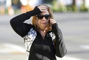 A woman speaks on the phone while walking along the Las Vegas Strip near Mandalay Bay hotel and casino Monday