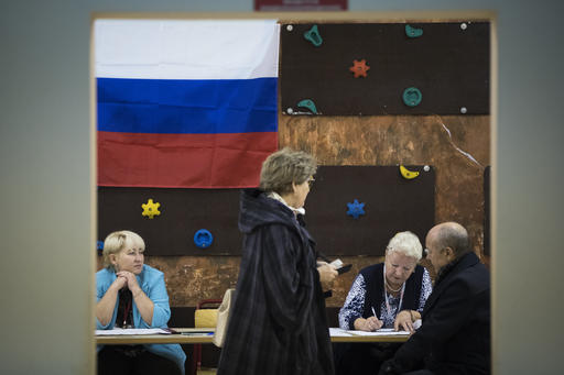 People register to get ballot papers at a polling station during a parliamentary elections in Moscow
