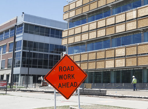 Workers toil on one of the buildings on the campus of the Veterans Administration hospital under construction Thursday