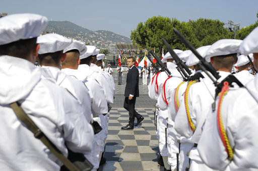 French President Emmanuel Macron reviews the troops during a ceremony in Nice