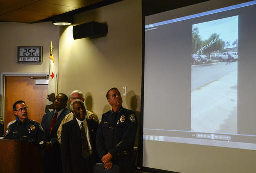 Authorities watch a video of the shooting scene at a news conference on Friday Sept. 30