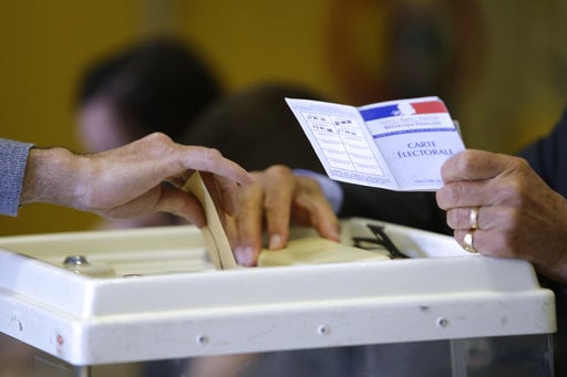 A man casts his ballot in the presidential runoff election between Emmanuel Macron and Marine Le Pen