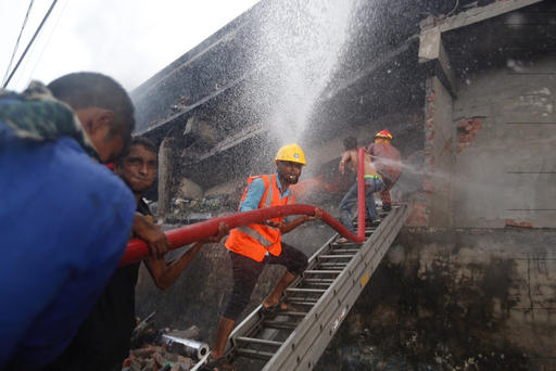 Firefighters work to put out a fire at a packaging factory in Tongi industry area outside Dhaka
