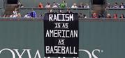 A banner is unfurled over the left field wall during the fourth inning of a baseball game between the Boston Red Sox and Oakland Athletics at Fenway Park in Boston