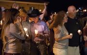 Mourners participate in a candlelight vigil held for the victims of a fatal shooting at the First Baptist Church of Sutherland Springs