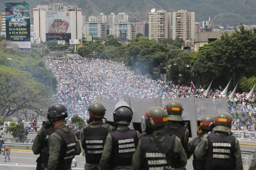 Bolivarian National Guards stand on a highway above an anti-government protest against Venezuelan President Nicolas Maduro's decree ordering a rewrite of the constitution in Caracas