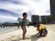 Kids play in the sand in Tumon