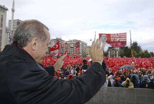 Turkish President Recep Tayyip Erdogan salutes the crowd of supporters in his hometown of Rize