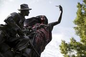 A statue depicting a Confederate soldier in Piedmont Park in Atlanta is vandalized with spray paint Monday