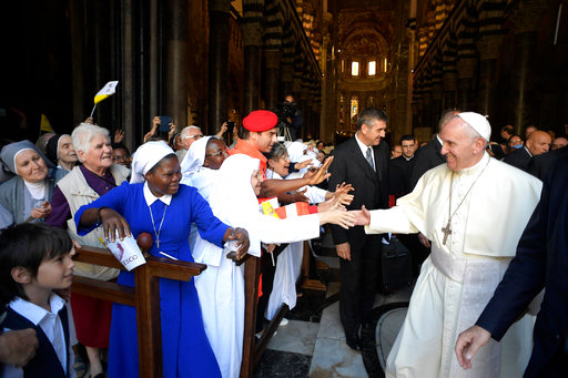 Pope Francis is greeted by faithful as he meets with bishops