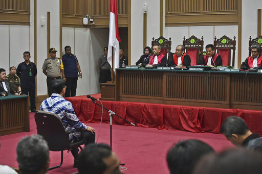 Jakarta Governor Basuki "Ahok" Tjahaja Purnama sits on the defendant's chair as he attends his sentencing hearing in Jakarta