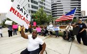 Mario Henderson leads chants of "save Medicaid