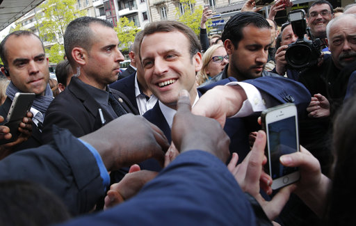 French independent centrist presidential candidate Emmanuel Macron shakes hands to supporters as he campaigns in Rodez