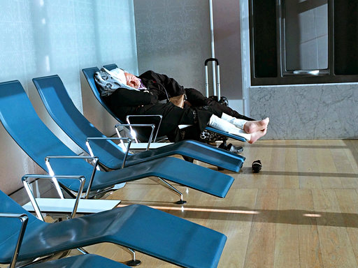 Passengers of cancelled flights wait in Hamad International Airport (HIA) in Doha