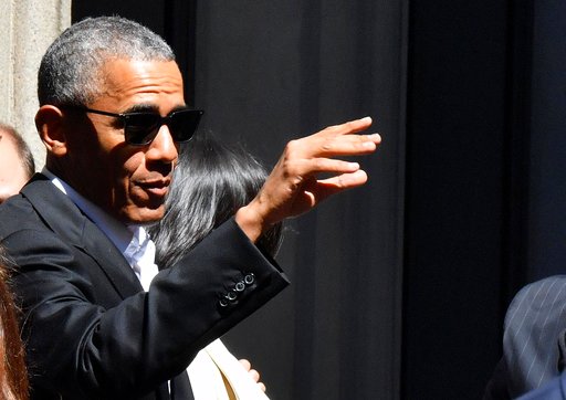 United States former President Barack Obama waves as he leaves his hotel