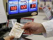 A customer is handed a Powerball ticket in Omaha