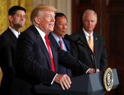 President Donald Trump speaks in the East Room accompanied by House Speaker Paul Ryan of Wis.