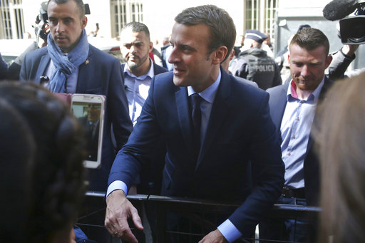 French centrist presidential candidate Emmanuel Macron leaves his apartment
