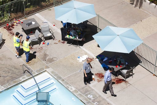 People look over the scene Monday