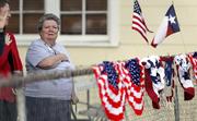 Donna King stands for the national anthem during a Veterans Day event