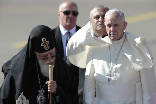 Pope Francis walks with Georgian Orthodox Patriarch Ilia II after his landing in Tbilisi