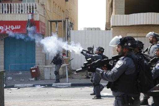 Israeli border border police fire tear gas at Palestinians during clashes in the West Bank city of Bethlehem