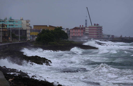 Waves crash against a seawall in Baracoa