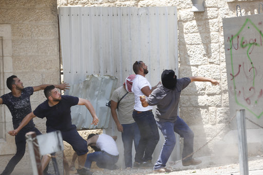 Palestinians throw stones against Israeli soldiers during clashes in the West Bank city of Bethlehem