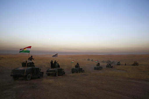 A Peshmerga convoy drives towards a frontline in Khazer