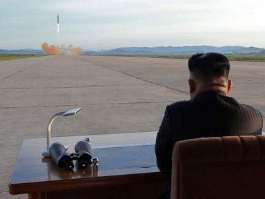 North Korean leader Kim Jong Un watches a launching drill of the medium-and-long range strategic ballistic rocket Hwasong-12 at an undisclosed location