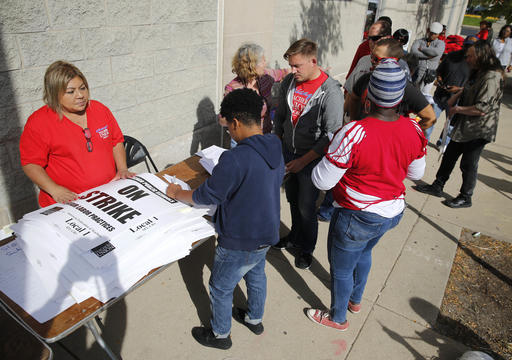 Chicago Teachers Union members pick up strike material outside union's strike headquarters Monday